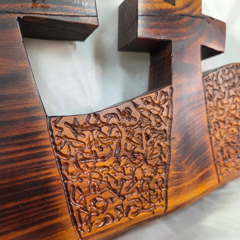 A Bois D'Arc decorative wall plaque featuring three stylized Christian crosses cut from a single slab, hand carved with burned finish sho sugi ban