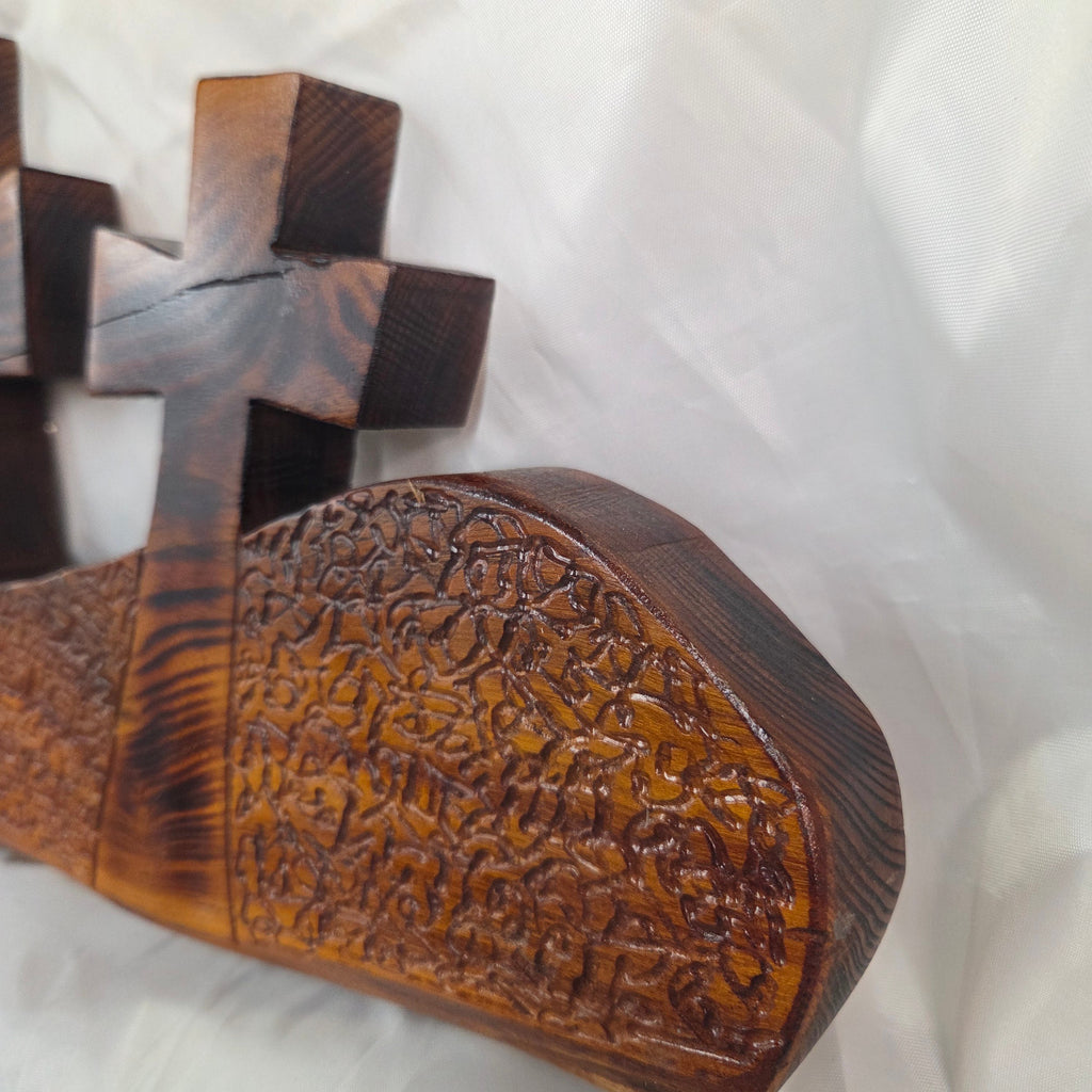 A Bois D'Arc decorative wall plaque featuring three stylized Christian crosses cut from a single slab, hand carved with burned finish sho sugi ban