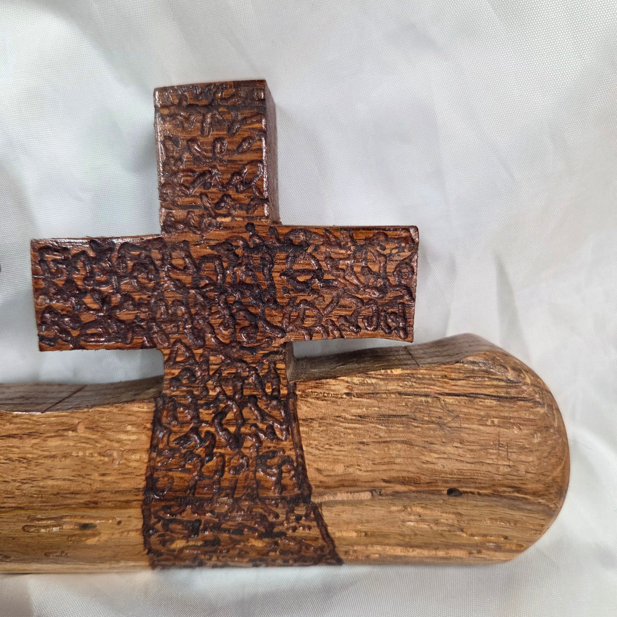 A white oak decorative wall plaque featuring three stylized Christian crosses cut from a single slab, hand carved with dark brown stained crosses and natural color base