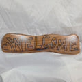 hand carved white oak sign reading welcome in Blue epoxy fill