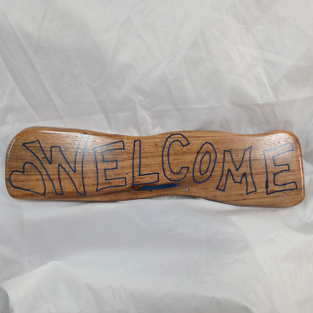 hand carved white oak sign reading welcome in Blue epoxy fill