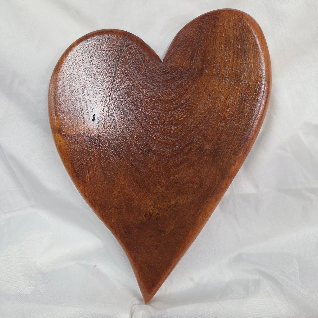 A heart-shaped mesquite wall art with a polished finish, showcasing natural wood grain