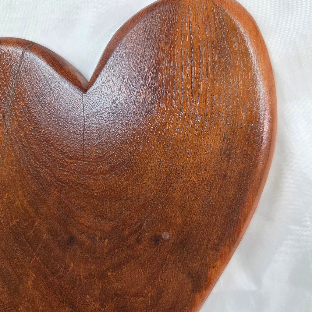 A heart-shaped mesquite wall art with a polished finish, showcasing natural wood grain