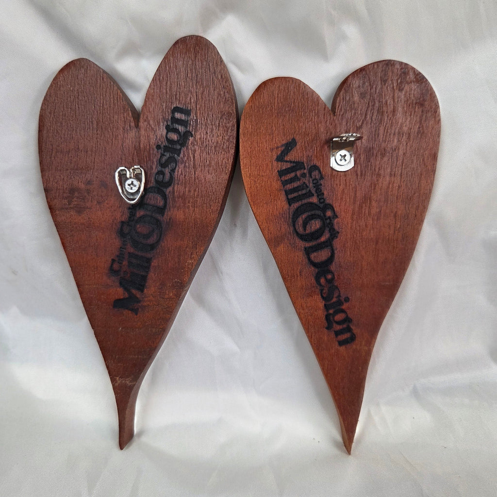 back view of A pair of heart-shaped mesquite wall art with a polished finish, showcasing natural wood grain