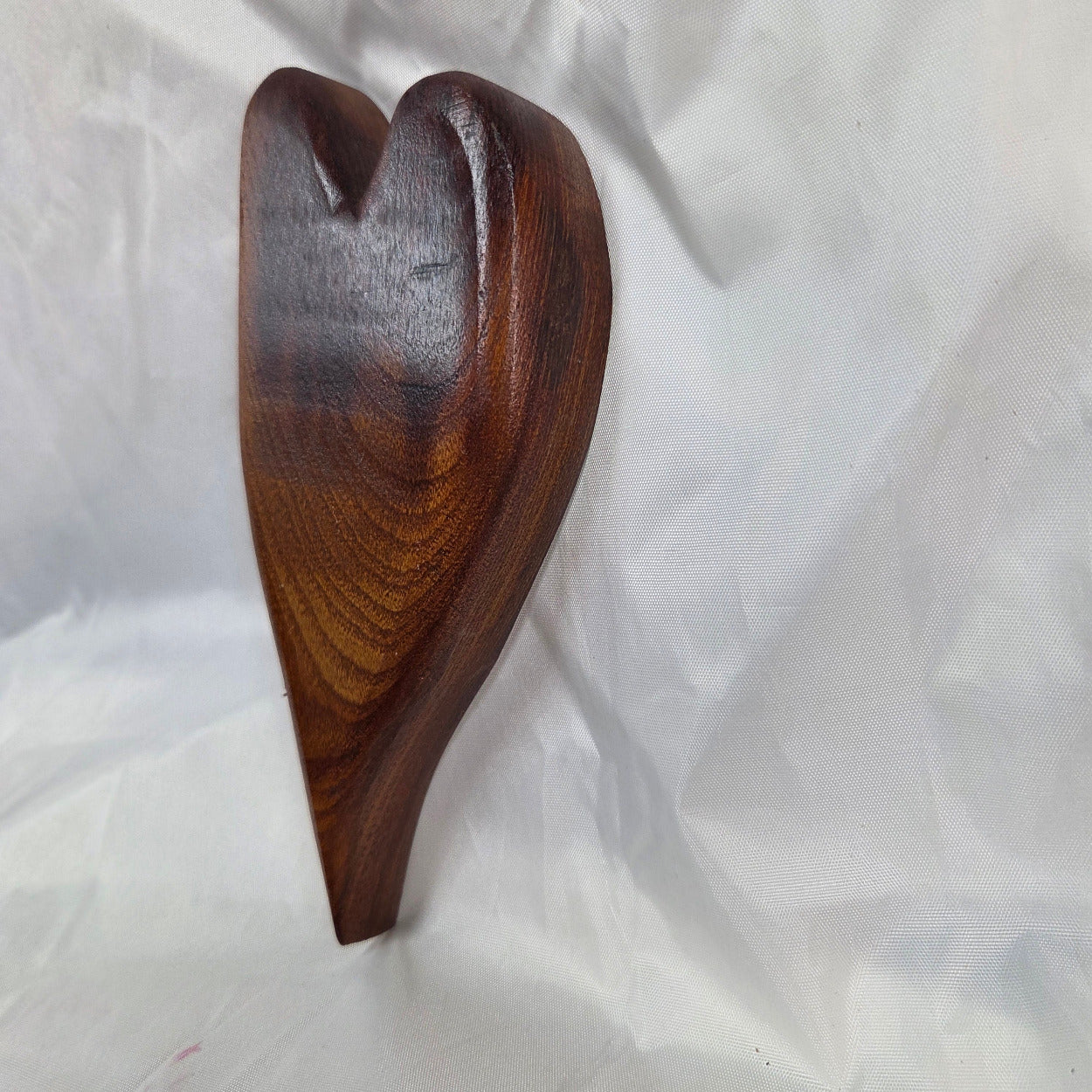 A heart-shaped mesquite handing plaque, showcasing natural wood grain