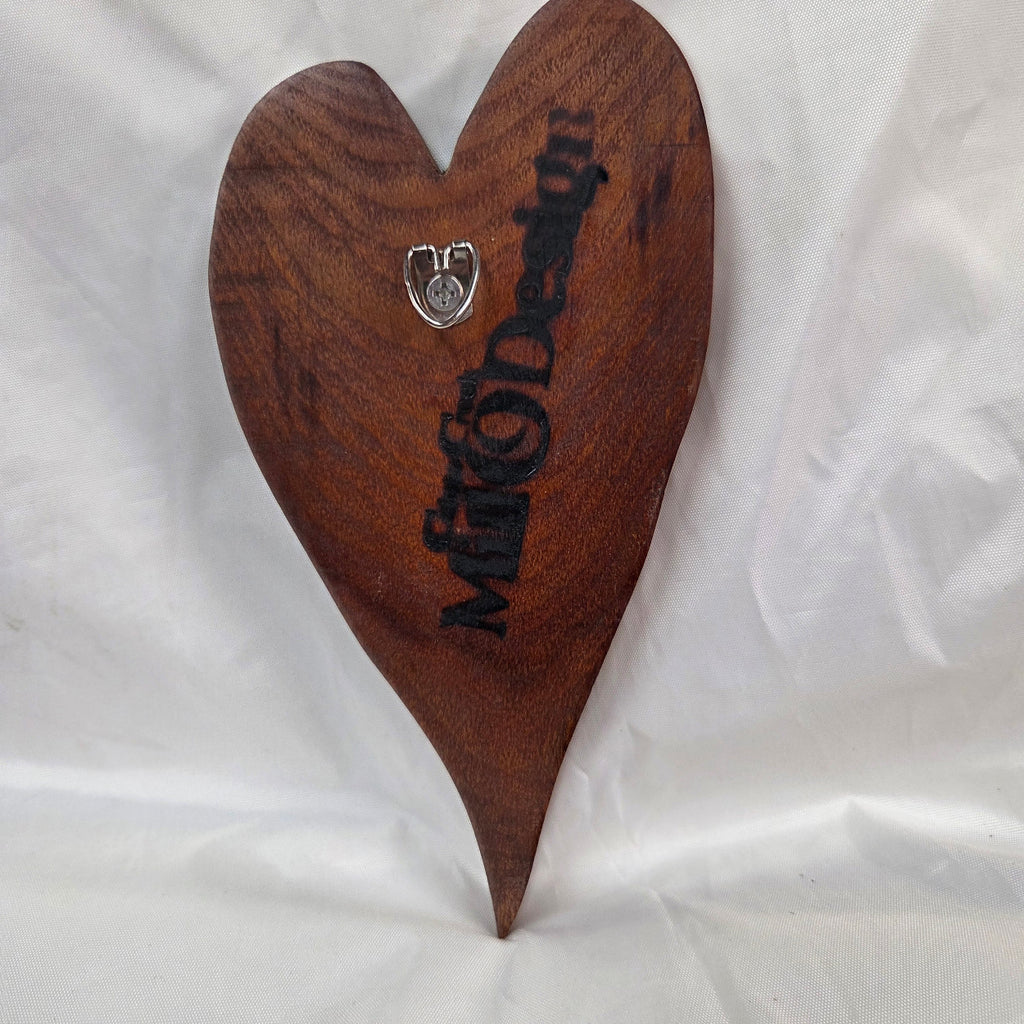 A heart-shaped mesquite handing plaque, showcasing natural wood grain