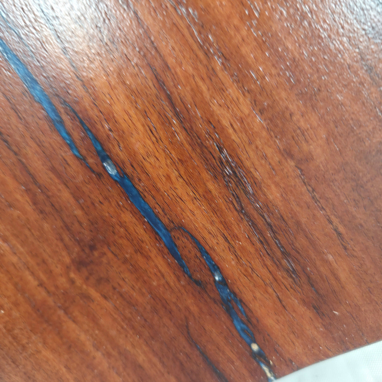 close up A carved mesquite wall plaque shaped like the state of Texas, with Blue epoxy fill and semi-gloss finish