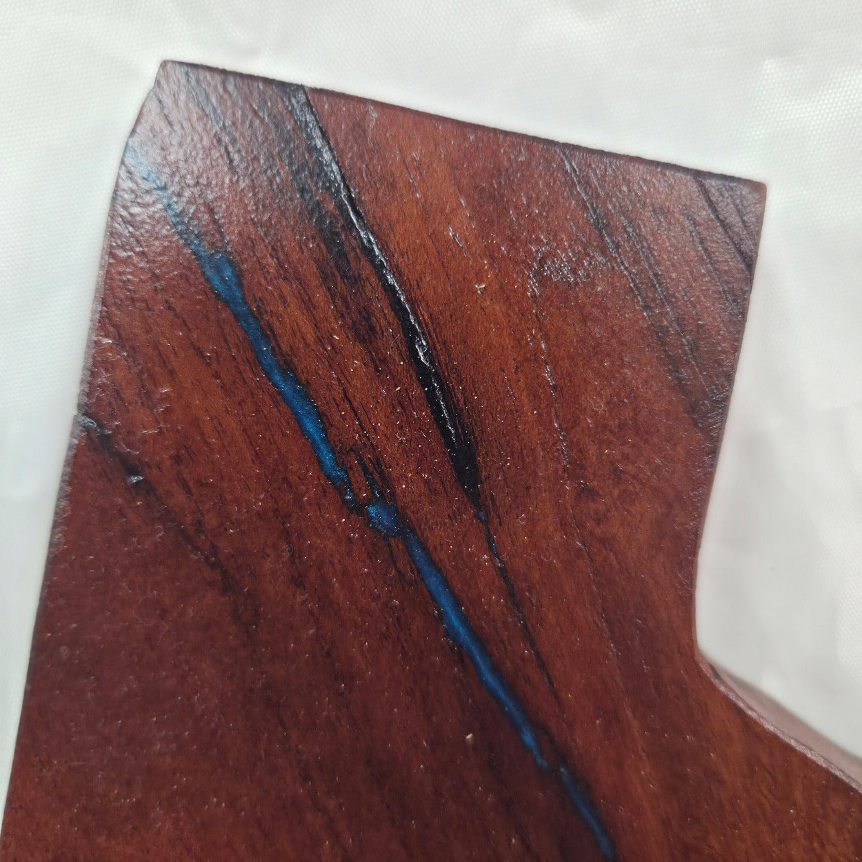 close up A carved mesquite wall plaque shaped like the state of Texas, with Blue epoxy fill and semi-gloss finish