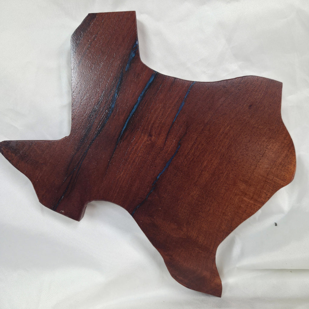 A carved mesquite wall plaque shaped like the state of Texas, with Blue epoxy fill and semi-gloss finish