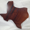 A carved mesquite wall plaque shaped like the state of Texas, with Blue epoxy fill and semi-gloss finish