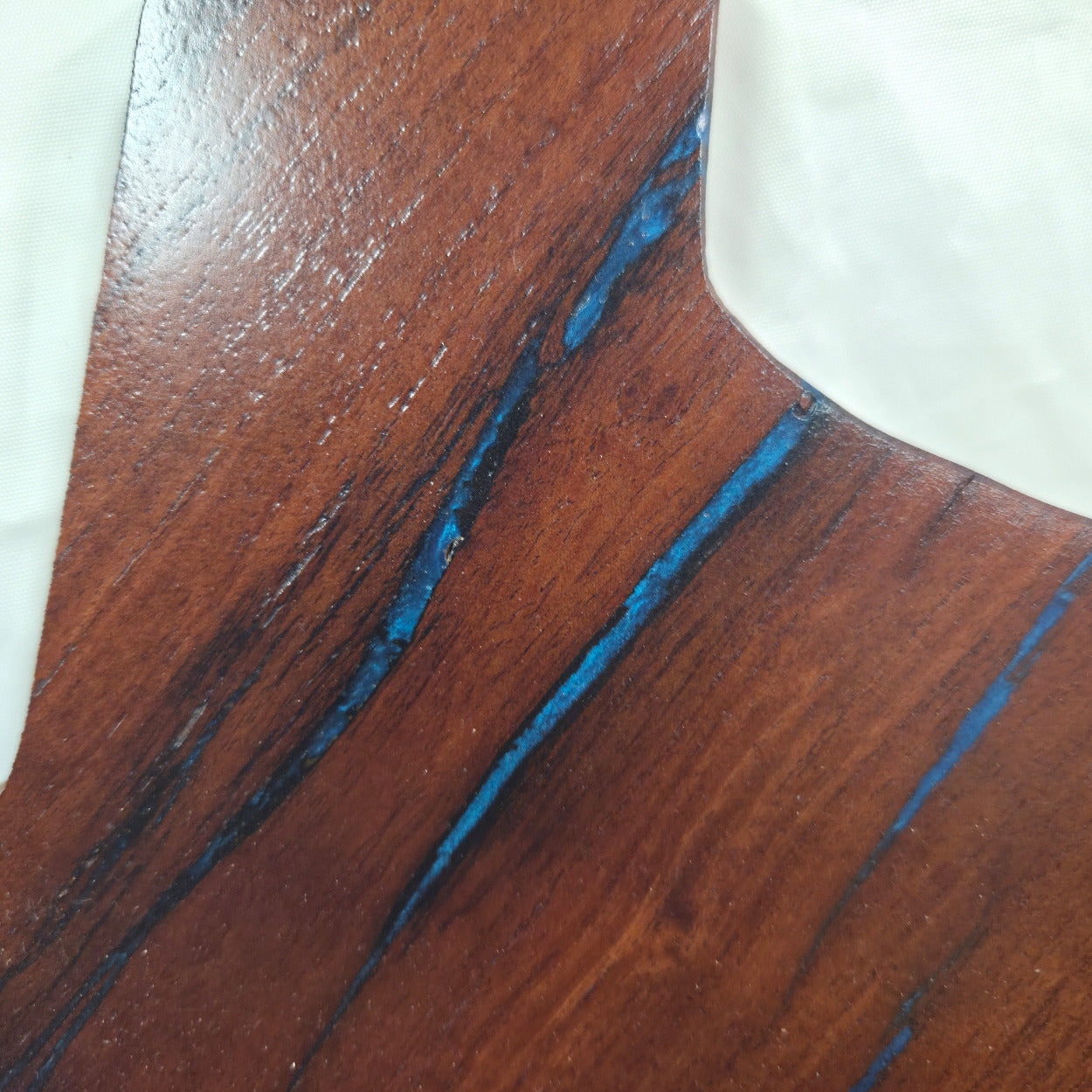 close up A carved mesquite wall plaque shaped like the state of Texas, with Blue epoxy fill and semi-gloss finish