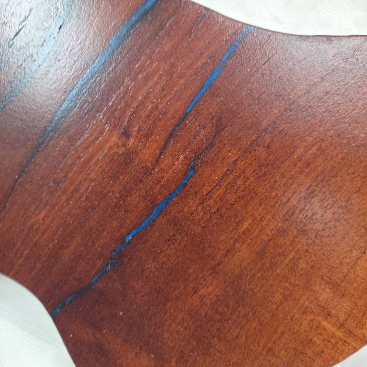 close up A carved mesquite wall plaque shaped like the state of Texas, with Blue epoxy fill and semi-gloss finish