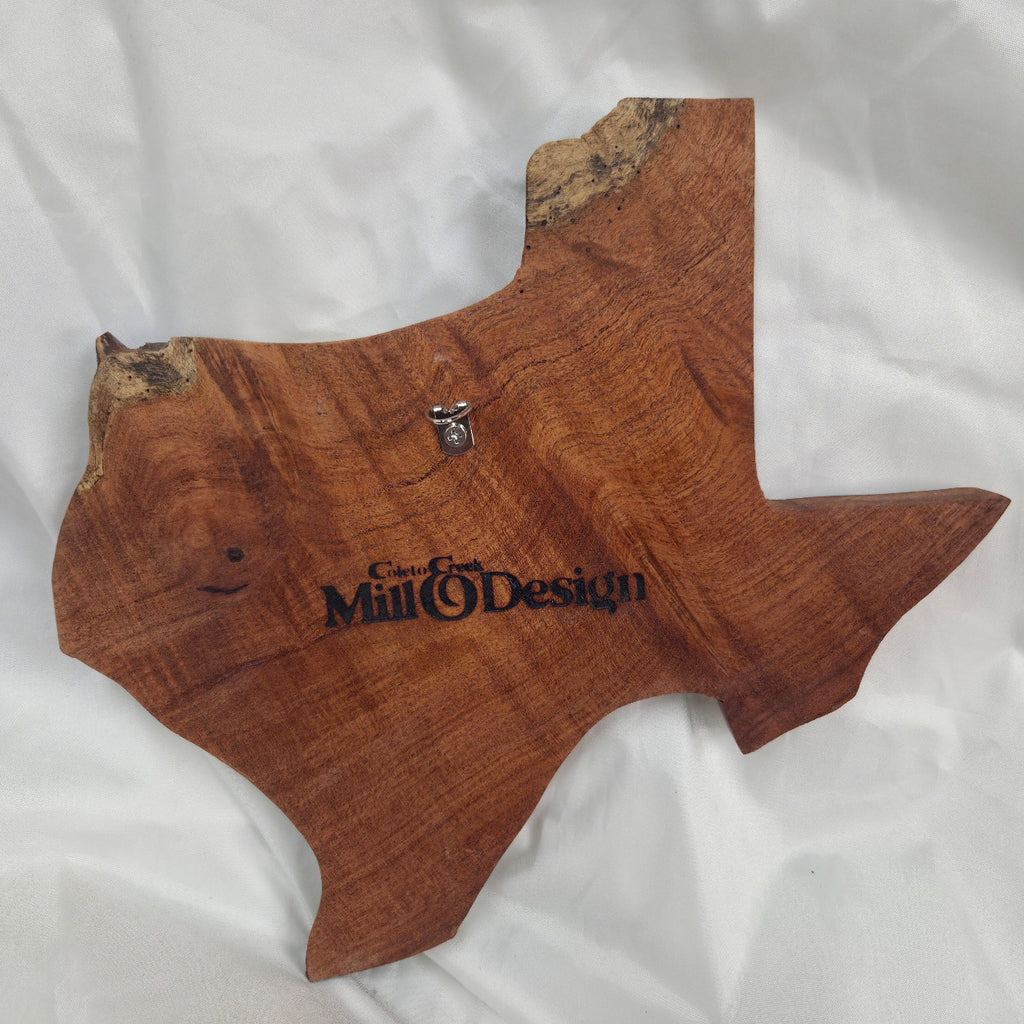 back view A rustic Texas-shaped wall art plaque made from mesquite wood with a dark, textured natural with natural deformities