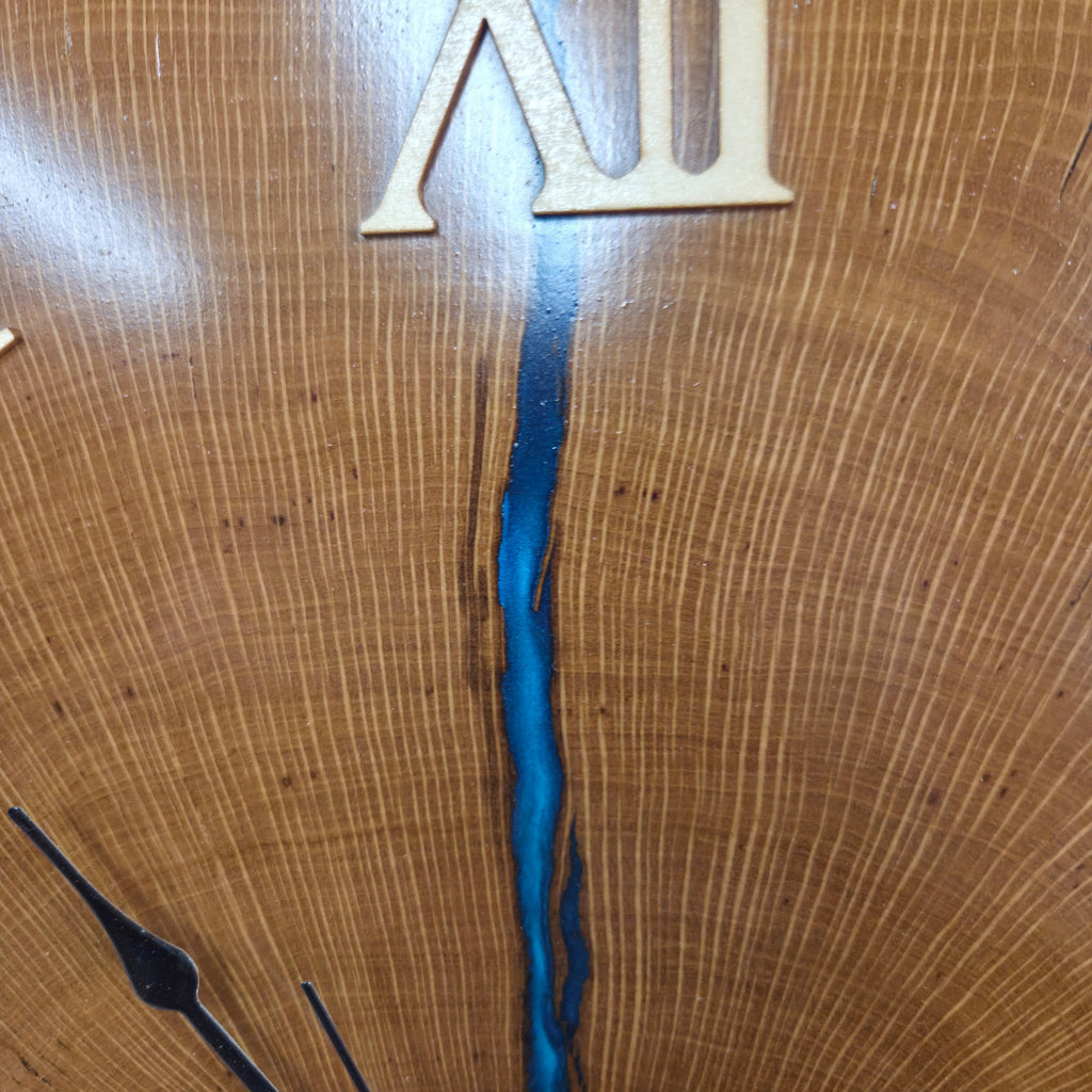 Large live edge Live Oak clock with wooden roman numerals with blue epoxy inlay and black clock arms