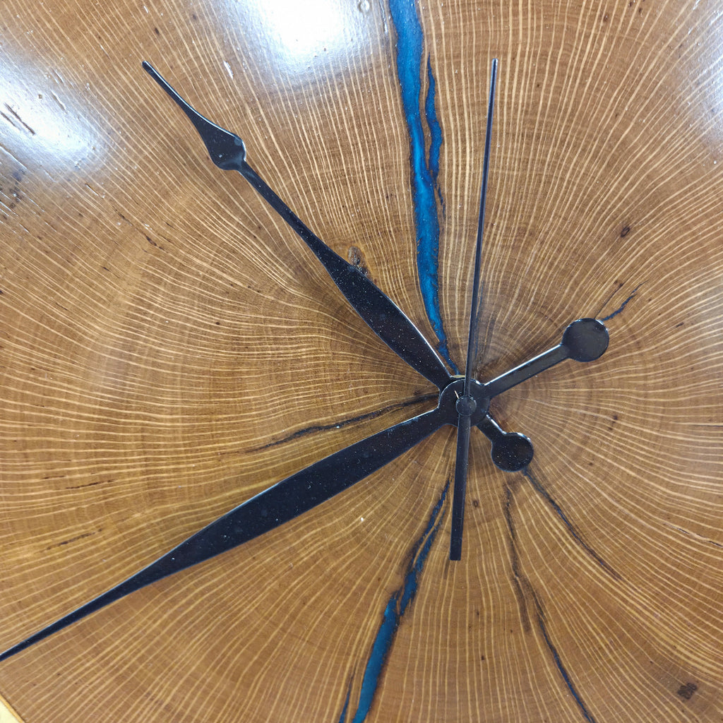 Large live edge Live Oak clock with wooden roman numerals with blue epoxy inlay and black clock arms
