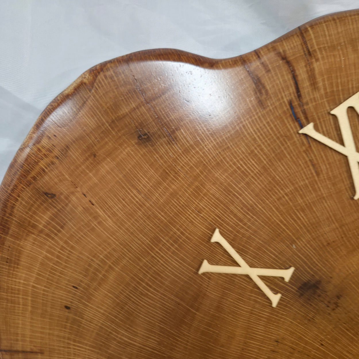 Large live edge Live Oak clock with wooden roman numerals with blue epoxy inlay and black clock arms