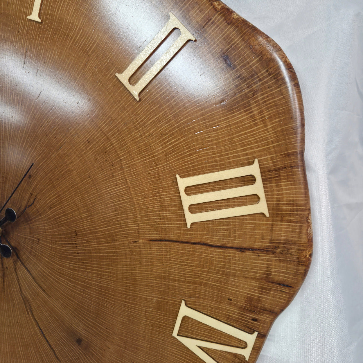 Large live edge Live Oak clock with wooden roman numerals with blue epoxy inlay and black clock arms