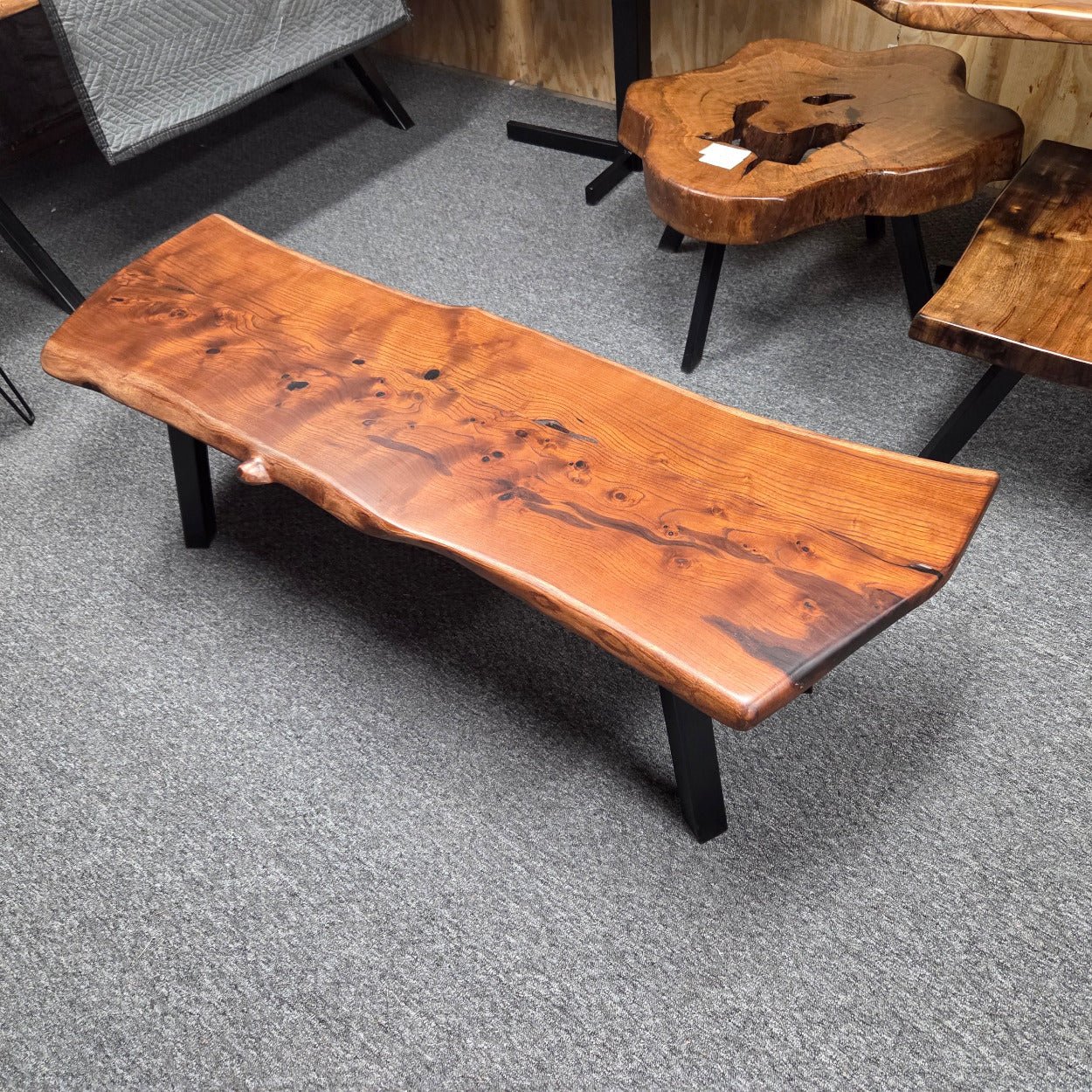beautiful Bois D'Arc Bench Live edge rustic with black metal legs.