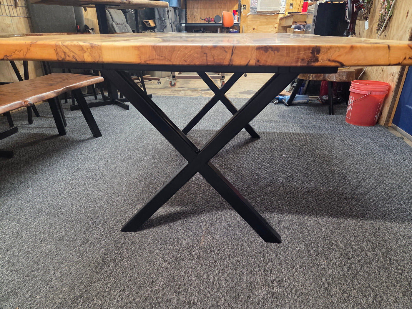 Elm dining table. live edge with rustic feel on black x-style metal legs