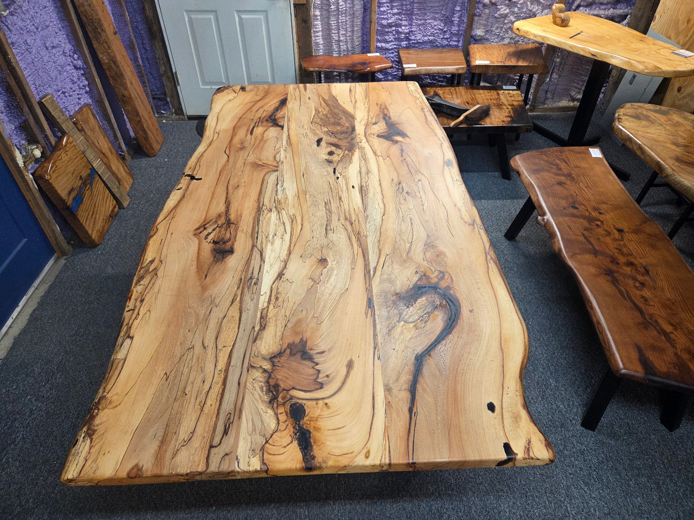Elm dining table. live edge with rustic feel on black x-style metal legs