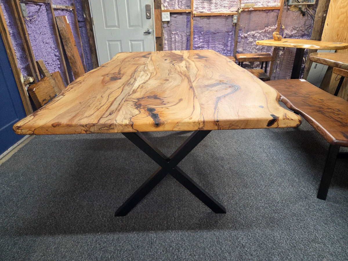 Elm dining table. live edge with rustic feel on black x-style metal legs