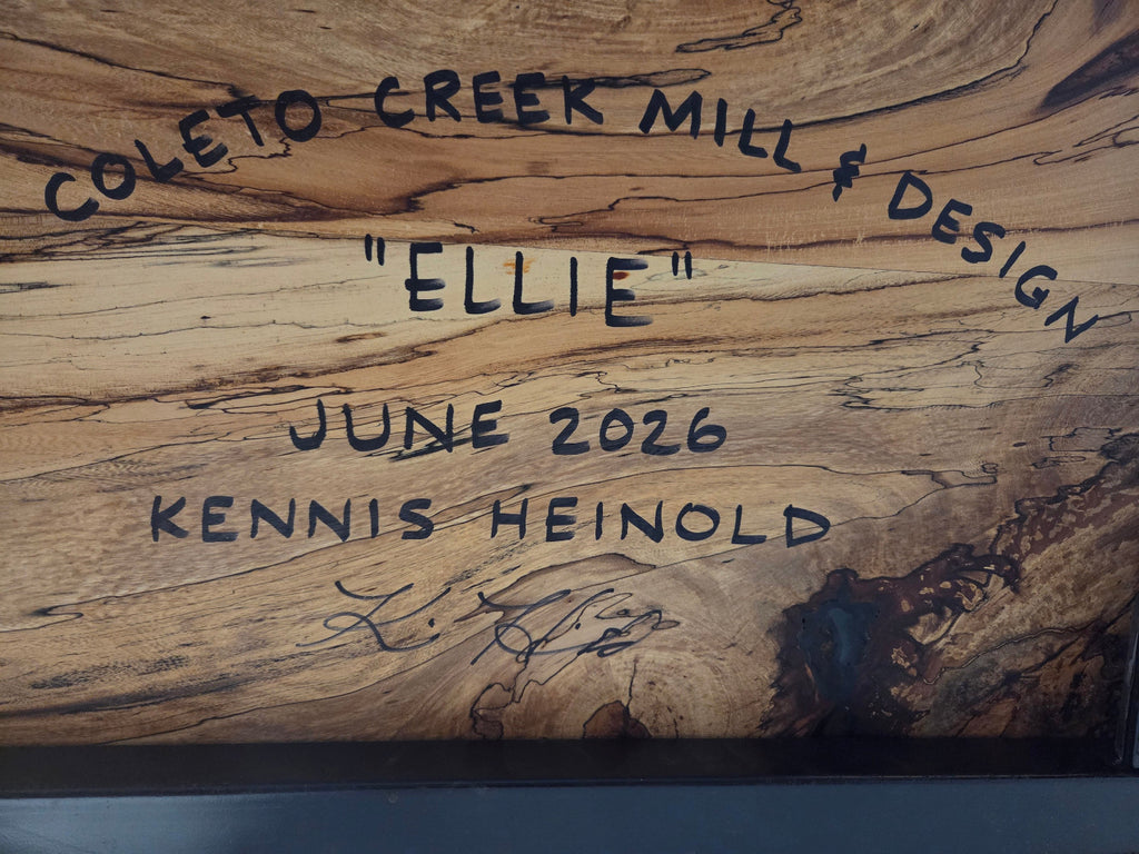 Elm dining table. live edge with rustic feel on black x-style metal legs
