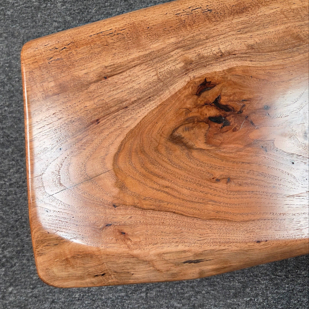 closeup view Handcrafted live edge pecan coffee table with Honey Oak stain and black steel legs