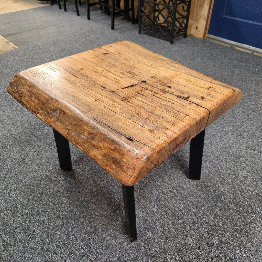 Handcrafted pecan coffee table with natural wood character and black metal legs 