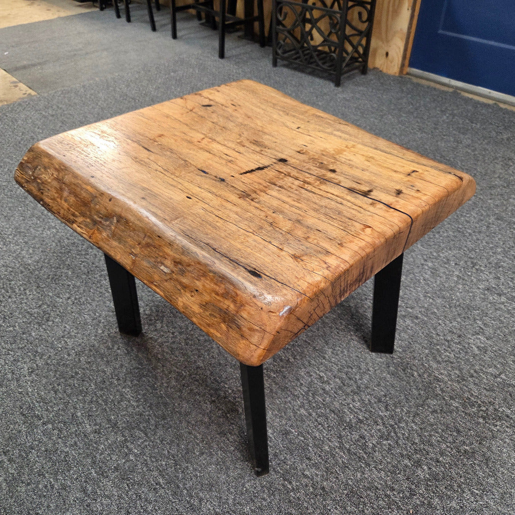 Handcrafted pecan coffee table with natural wood character and black metal legs 