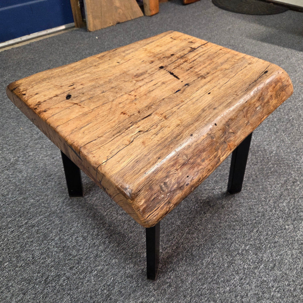 Handcrafted pecan coffee table with natural wood character and black metal legs 