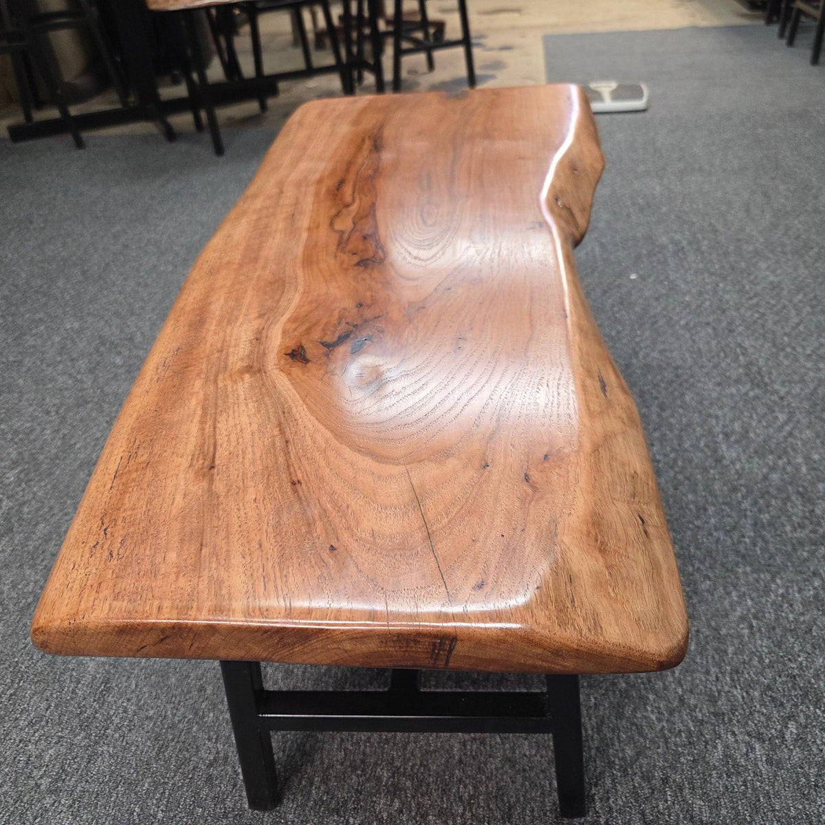 Handcrafted live edge pecan coffee table with Honey Oak stain and black steel legs
