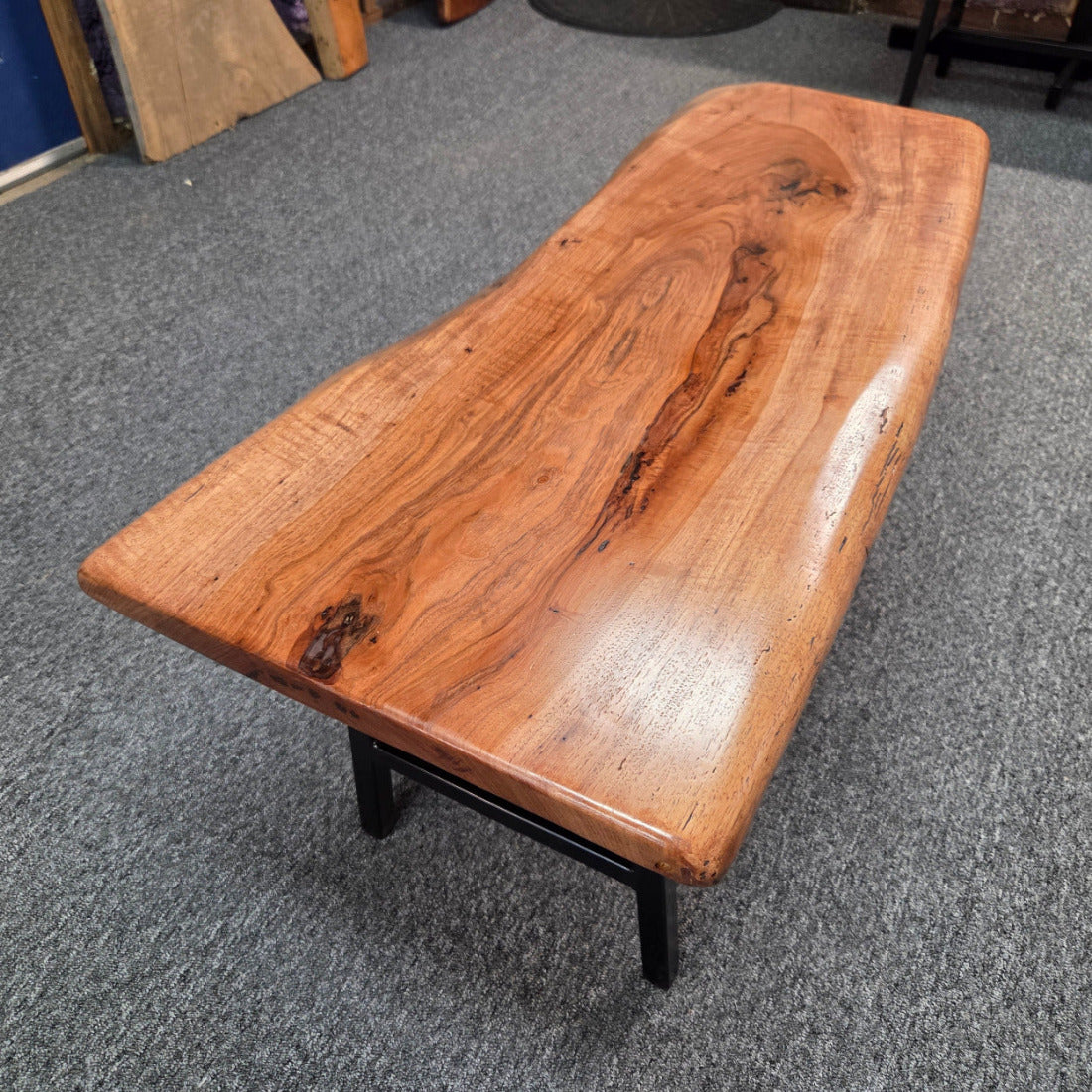 Handcrafted live edge pecan coffee table with Honey Oak stain and black steel legs