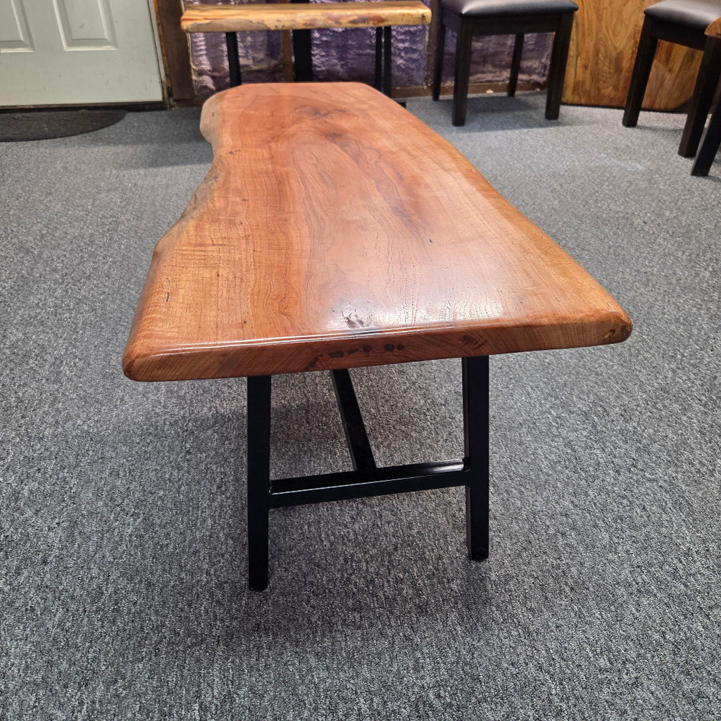 side view Handcrafted live edge pecan coffee table with Honey Oak stain and black steel legs