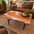 Handcrafted pecan live edge coffee table with black steel frame in a rustic living room
