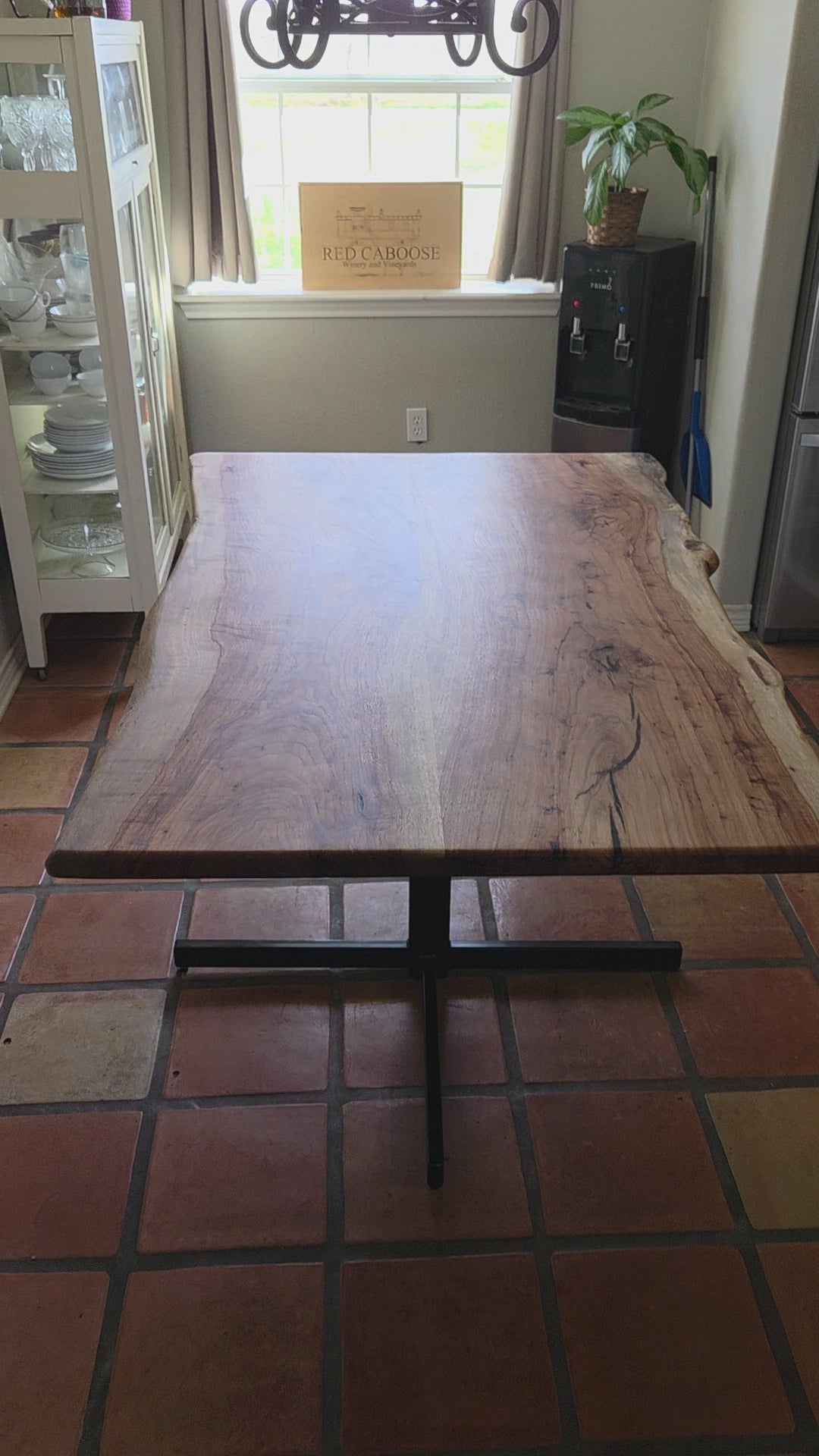 Live edge Pecan Breakfast table with black metal pedestal stand in natural color.